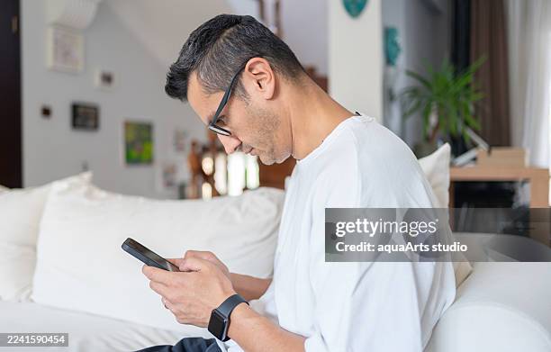 man with wrong angle look at the smartphone, causing neck problems - posture stock pictures, royalty-free photos & images