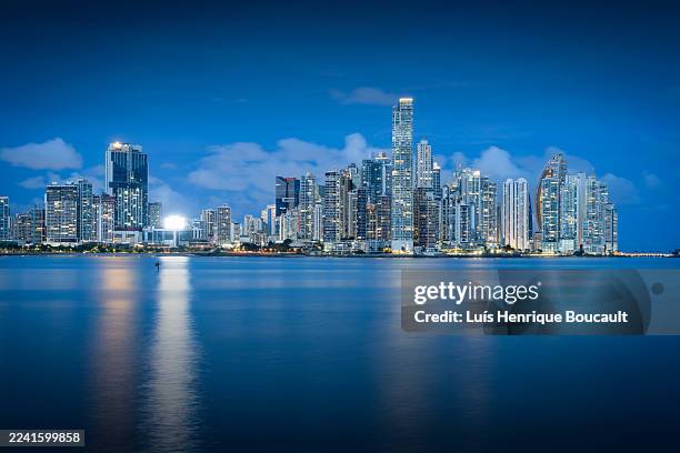 panoramic view of panama city skyline and the sea at blue hour - panama stock pictures, royalty-free photos & images