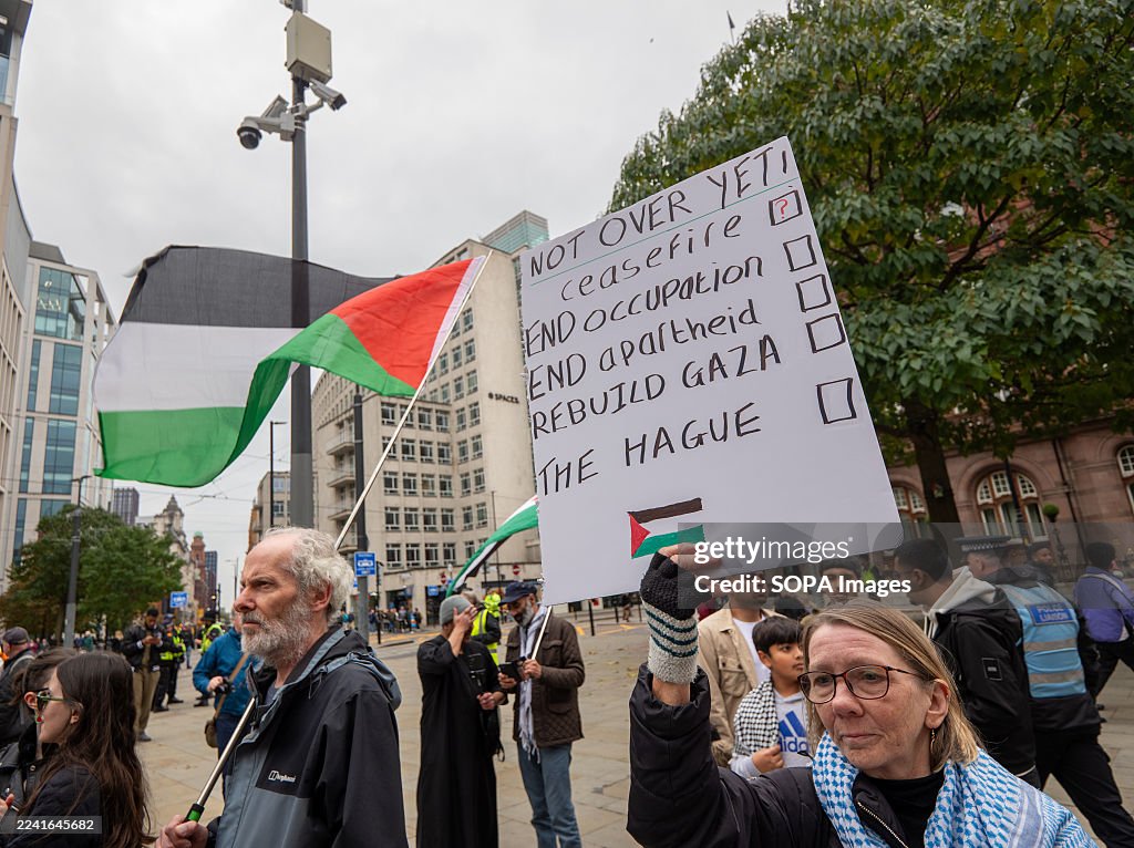 Protestet A protester holds a 'Not over yet' placard during the Pro- Palestine ...