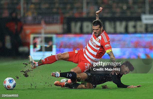 Christopher Trimmel of Union Berlin is challenged by Jens Castrop of Mönchengladbach during the Bundesliga match between 1. FC Union Berlin and...