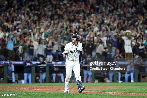 Eugenio Suárez of the Seattle Mariners reacts after hitting a grand slam against the Toronto Blue Jays during the eighth inning to give the Mariners...