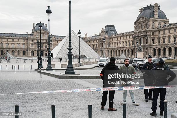 French police officers stand in front of the Louvre Museum after a robbery in Paris, France, on October 19, 2025. Robbers break into the Louvre and...