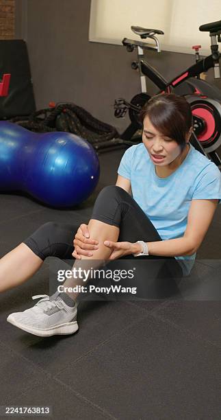 asian woman gym exercose suffer calf pain - ankle weights stock pictures, royalty-free photos & images
