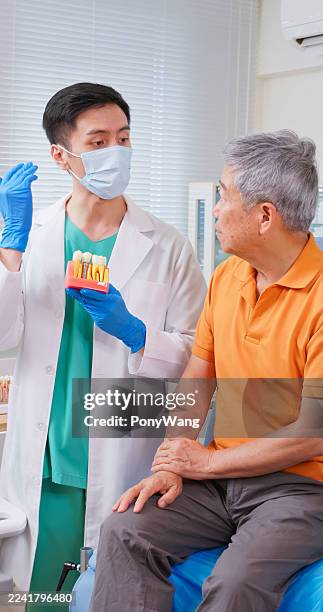 male dentist explain dental implant to patient - teeth-3d-model stock pictures, royalty-free photos & images