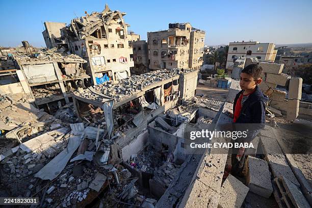 Boy looks at the rubbles of buildings destroyed in an Israeli strike in Bureij, central Gaza Strip, on October 20, 2025. US President Donald Trump...