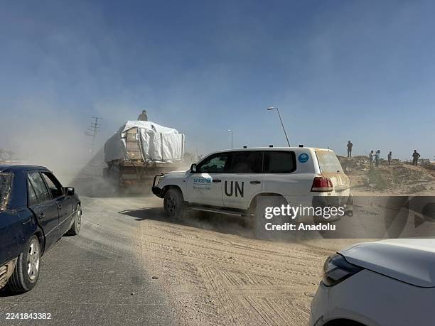Aid trucks, carrying food and fuel aid, under the supervision of international organizations affiliated with the United Nations, reach Deir Al Balah...