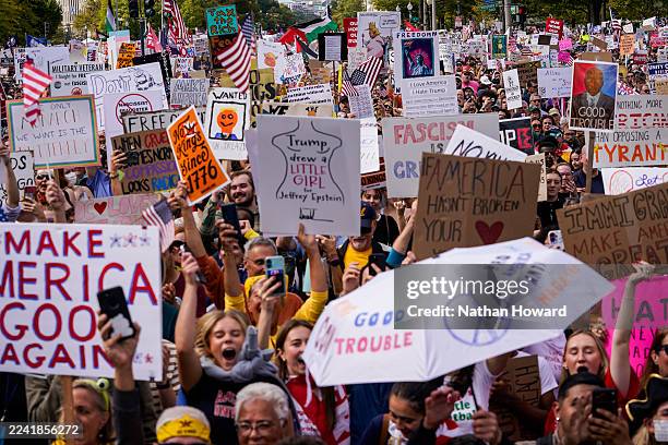 Protestors march along Pennsylvania Avenue during the second "No Kings" protest on October 18, 2025 in Washington, DC. Organizers expect millions to...