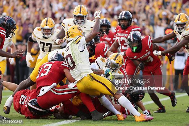 Raleek Brown of the Arizona State Sun Devils scores the game-winning one-yard rushing touchdown against the Texas Tech Red Raiders during the final...