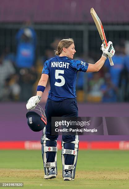 Heather Knight of England celebrates her century during the ICC Women's Cricket World Cup India 2025 match between India and England at Holkar...