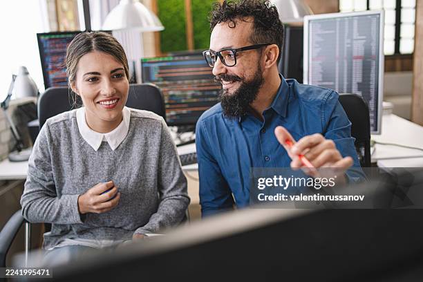 couple, software engineer developer use computer, work on program coding together at the office. programming language development technology, freelance job concept - html stock pictures, royalty-free photos & images