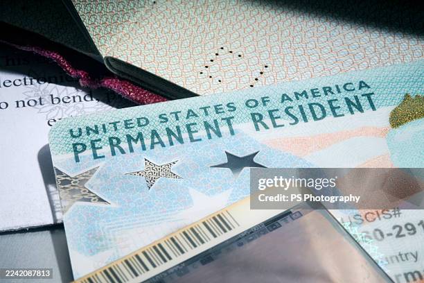 us permanent resident card (green card) placed among various official documents - green card stock pictures, royalty-free photos & images