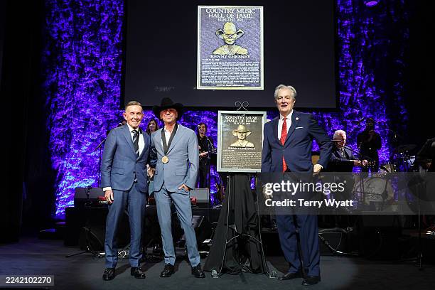Joe Galante, Kenny Chesney and Museum CEO, Kyle Young speak onstage during the Medallion Ceremony for the Class of 2025 at Country Music Hall of Fame...