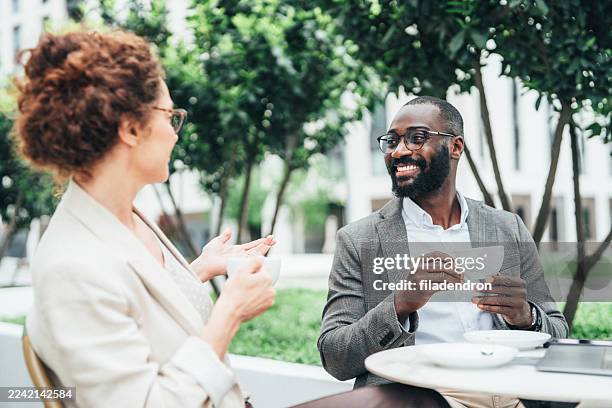 business people working at sidewalk cafe - sidewalk cafe stock pictures, royalty-free photos & images