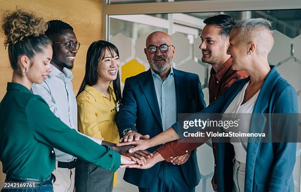motivating the team. - hand stack stock pictures, royalty-free photos & images