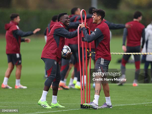 Bukayo Saka and Piero Hincapie of Arsenal laugh during a training session at Sobha Realty Training Centre on October 20, 2025 in London Colney,...
