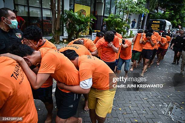 Indonesian police parade a group of some 34 men arrested early on October 19 for allegedly holding a "gay sex party" at a hotel in Surabaya, the...
