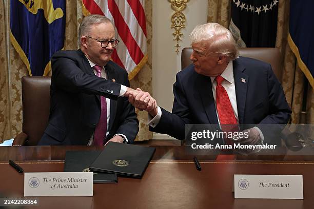 Prime Minister of Australia Anthony Albanese and U.S. President Donald Trump shake hands after signing a $8.5 billion rare earth minerals agreement...