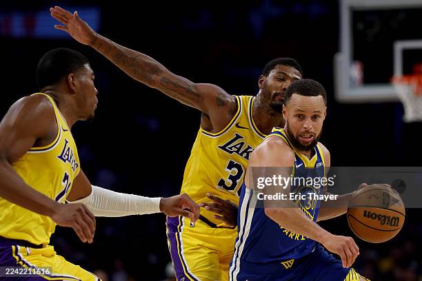 Los Angeles, CA Golden State Warriors guard Stephen Curry dribbles against Los Angeles Lakers forward Rui Hachimura during the first half of an NBA...