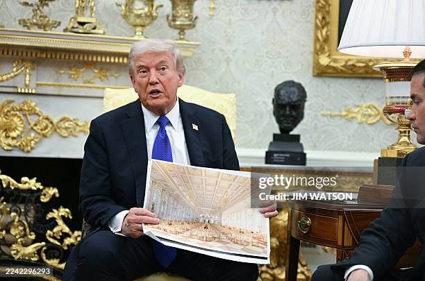 President Donald Trump shows an image of his planned ballroom as he meets with NATO Secretary General Mark Rutte in the Oval Office of the White...