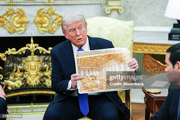 President Donald Trump holds a rendering of the planned White House ballroom during a meeting with Mark Rutte, secretary general of the North...