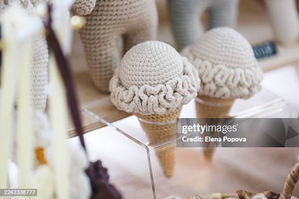 beige colored knitting interior decorations look like ice cream cone at the craft design market - mental wellbeing stock pictures, royalty-free photos & images