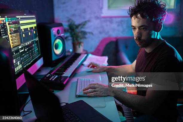producer mixing tracks on computer at home studio - songwriter stock pictures, royalty-free photos & images