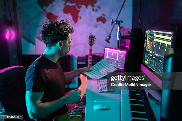 composer checking score in digital music studio - songwriter stock pictures, royalty-free photos & images