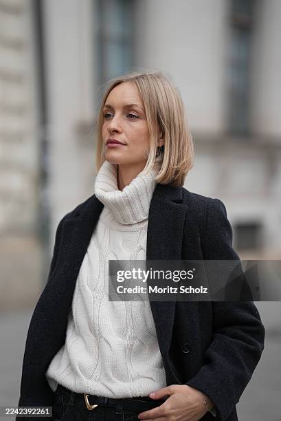 Marlies Pia Pfeifhofer is seen wearing a chic and minimalist winter look, featuring a black tailored wool coat by Samsoe Samsoe layered over a chunky...