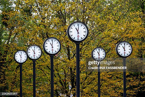 Clocks of the art installation 'Zeitfeld' by German artist Klaus Rinke are seen in Duesseldorf, western Germany, on October 23, 2025. Daylight Saving...