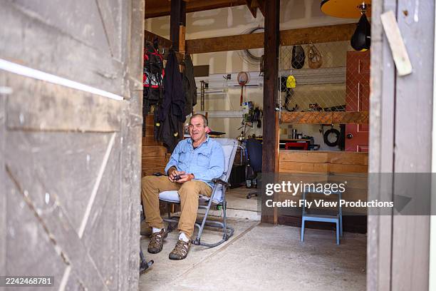 senior man relaxing in man cave - man cave stock pictures, royalty-free photos & images