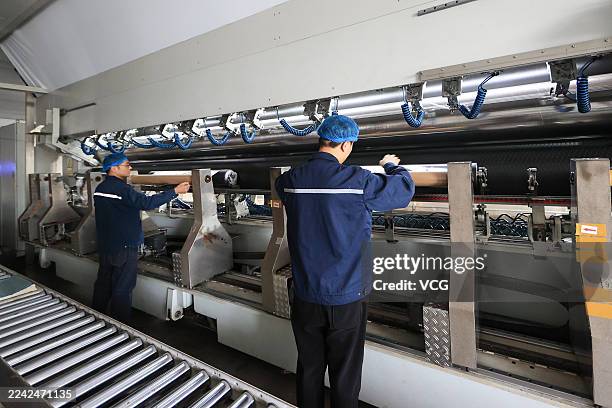 Employees work at a high-performance membrane manufacturing enterprise on October 21, 2025 in Lianyungang, Jiangsu Province of China.