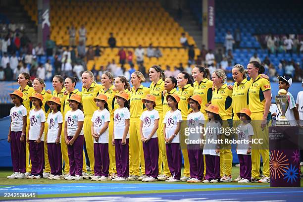 Players of Australia line up with their player mascots for the national anthems prior to the ICC Women's Cricket World Cup India 2025 match between...