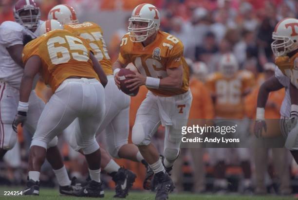Quarterback Peyton Manning of the Tennessee Volunteers rolls out of the pocket during the Volunteers 20-13 victory over the Alabama Crimson Tide at...