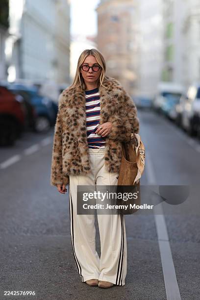 Karin Teigl with blonde short and straight hair seen wearing a statement Munthe faux fur jacket in a bold leopard print, layered over a Miu Miu...