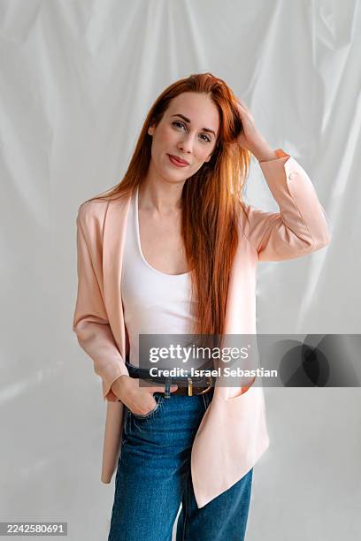 confident red haired woman posing in casual blazer - straight hair stock pictures, royalty-free photos & images