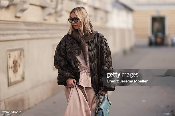 Karin Teigl with blonde short and straight hair seen wearing a rose-colored H&M silk dress paired with a matching H&M silk top for a tonal layered...