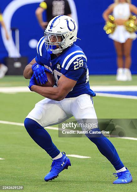 Jonathan Taylor of the Indianapolis Colts runs the ball against the Arizona Cardinals at Lucas Oil Stadium on October 12, 2025 in Indianapolis,...
