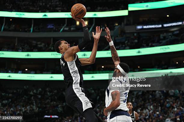 Victor Wembanyama of the San Antonio Spurs shoots over Anthony Davis of the Dallas Mavericks during the first half at American Airlines Center on...