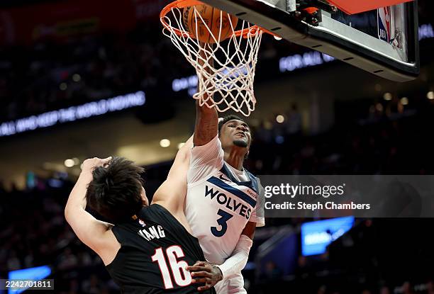 Jaden McDaniels of the Minnesota Timberwolves dunks against Yang Hansen of the Portland Trail Blazers during the first half at Moda Center on October...