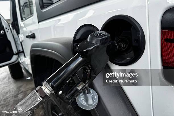 Fuel pump is seen connected to a car at a gas station in this illustration photo taken in Austin, United States on October 23, 2025.