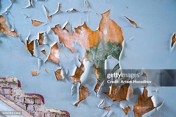 peeling blue paint on an old decaying wall revealing weathered textures and grunge layers, symbolizing neglect, dilapidated structures, and abstract patterns of time - deterioration stock pictures, royalty-free photos & images