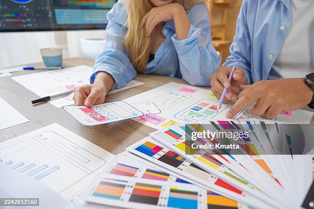 creative web designers brainstorming user interface ideas together in creative studio. - website wireframes stock pictures, royalty-free photos & images