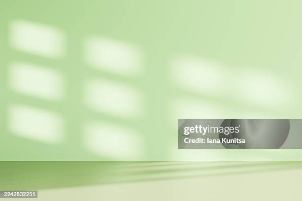 minimalist empty light green 3d background with soft natural sunlight and gentle window shadows on wall. tranquil scene perfect for wellness, eco-friendly, organic, interior design concepts. place for text. copy space. - mint green stock pictures, royalty-free photos & images