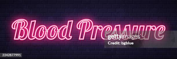 blood pressure - glowing neon text on brick wall background - brick wall background stock illustrations