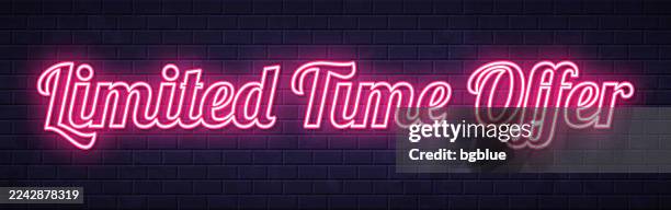 limited time offer - glowing neon text on brick wall background - limited time stock illustrations