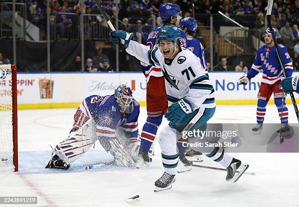 Macklin Celebrini of the San Jose Sharks reacts after a goal scored by teammate Adam Gaudette during the first period against the New York Rangers at...