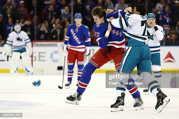 Matt Rempe of the New York Rangers and Ryan Reaves of the San Jose Sharks trade punches during the first period at Madison Square Garden on October...