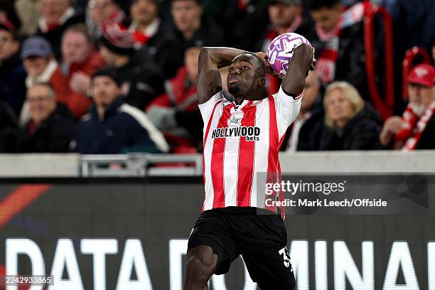 Michael Kayode of Brentford takes a long throw into the Liverpool penalty area during the Premier League match between Brentford and Liverpool at...