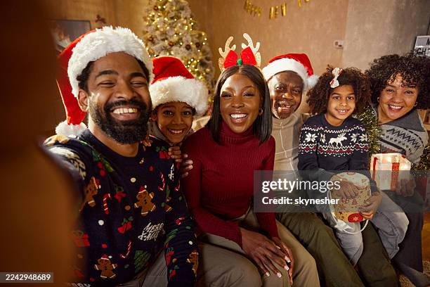 happy black extended family taking a selfie on christmas at home. - december stockfoto's en -beelden
