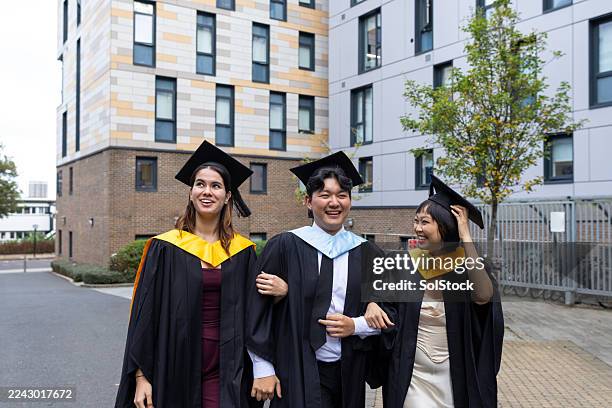 joyful graduates walking with confidence - student accommodation stock pictures, royalty-free photos & images